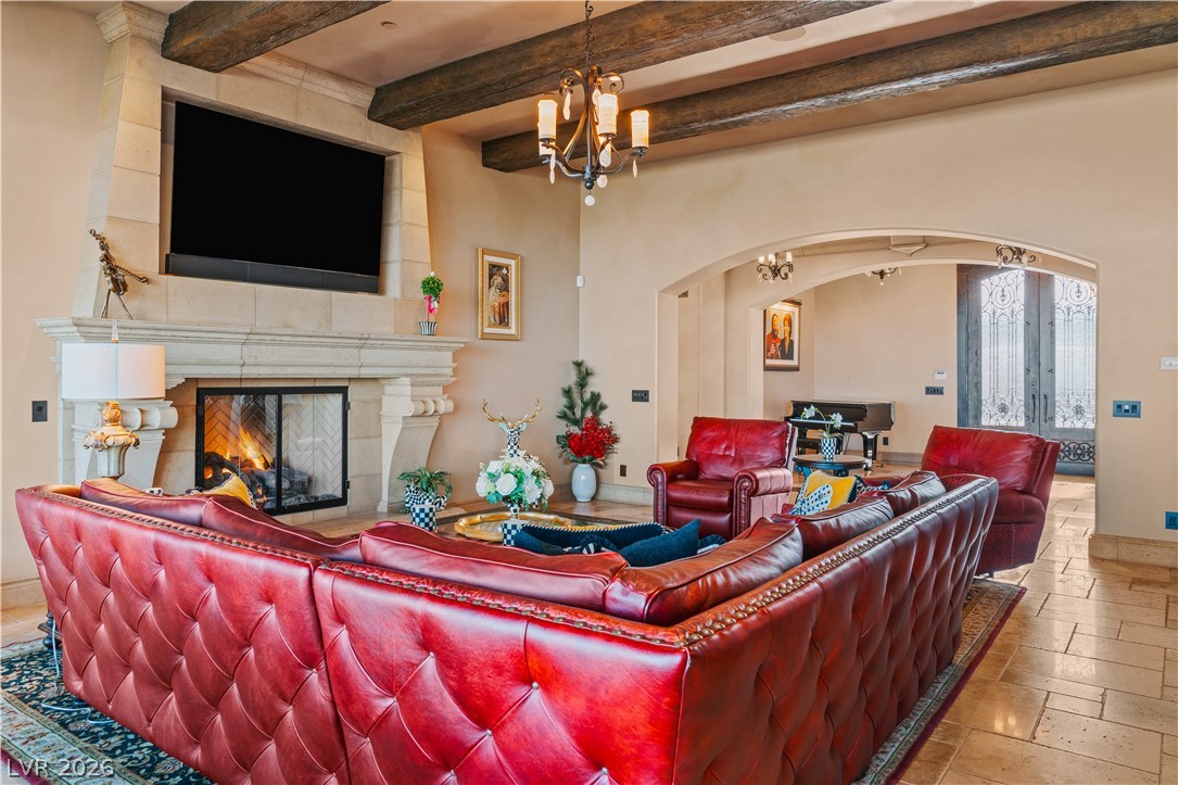 1123 Christian Road Henderson, NV 89002 - Photo 14 of 94 A grand fireplace hearth and exposed beams enhance this inviting living space.