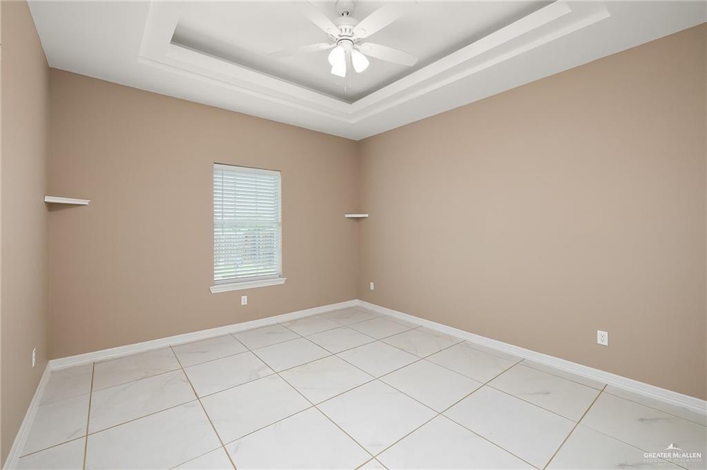 521 Oak Ridge Street Donna, TX 78537 - Photo 13 of 21 Recessed ceiling with an integrated ceiling fan, tiled flooring, and a single window with blinds