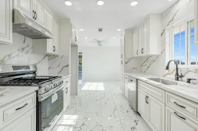 a kitchen with a stove a sink and a refrigerator