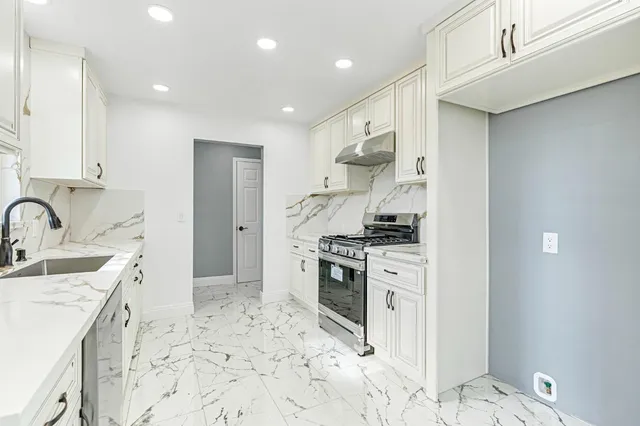 a kitchen with a sink stove and refrigerator