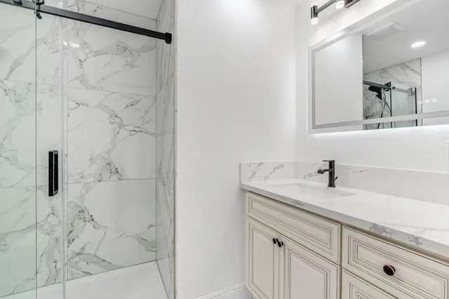 a bathroom with a sink and mirror