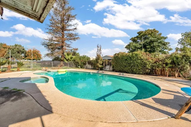 a view of a swimming pool with a yard