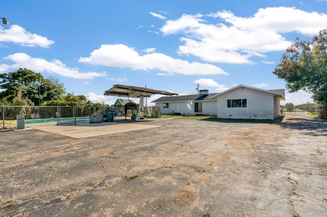a front view of house with yard and car parked