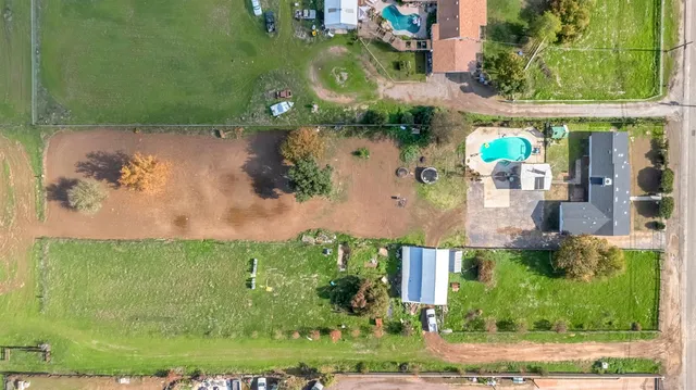 an aerial view of a house with a yard basket ball court