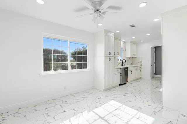 a view of a kitchen with a sink and cabinets