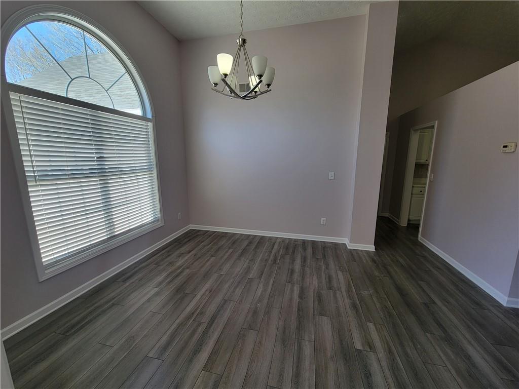 2213 Carlton Chase Road Dacula, GA 30019 - Photo 6 of 30 wooden floor in an empty room with a window