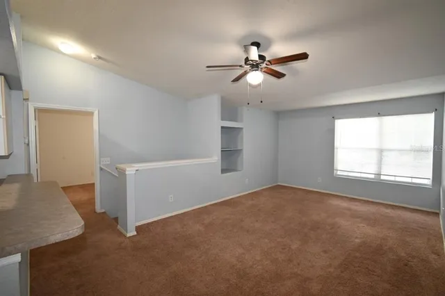 a view of a kitchen with a sink and dishwasher a refrigerator with wooden floor
