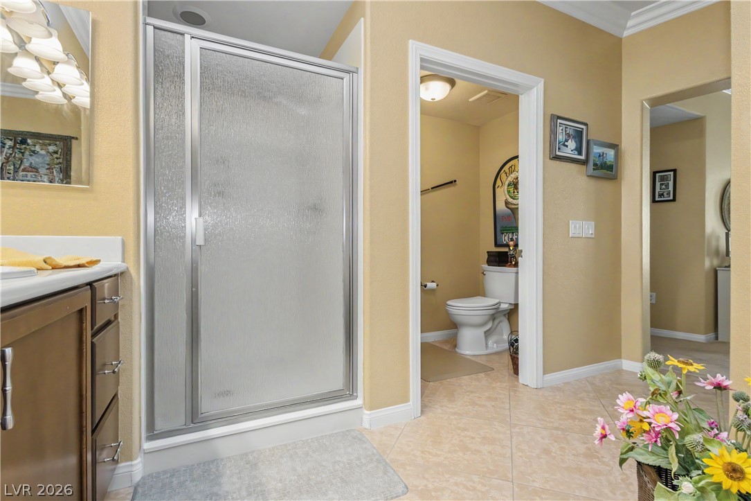 2555 Hampton Road, Unit 3308 Henderson, NV 89052 - Photo 39 of 65 A well-lit primary bathroom featuring a convenient shower enclosure and a separate commode area.