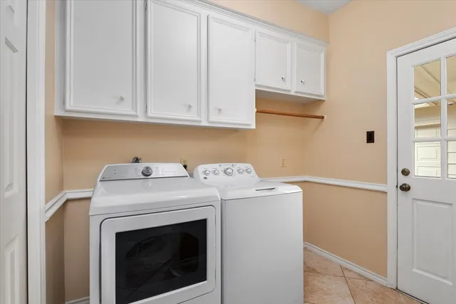 an empty room with chandelier fan