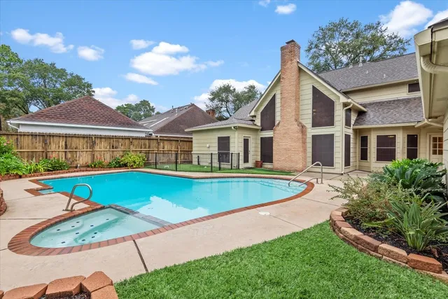 a view of a house with pool and a yard