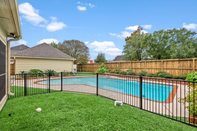 a view of a big house with a big yard and large tree