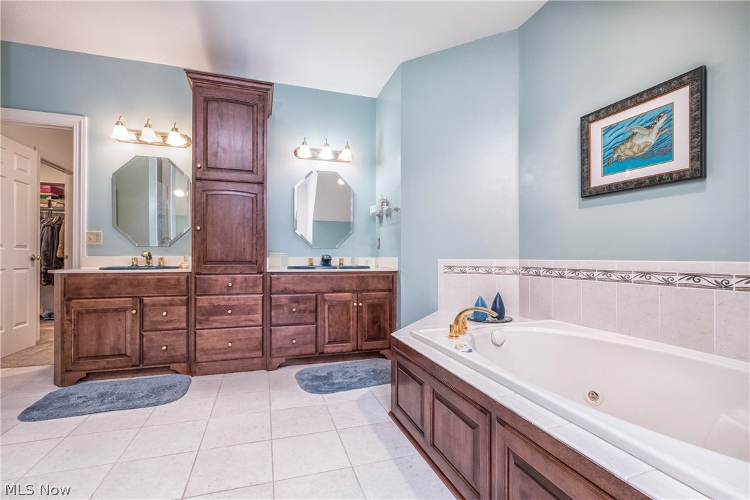 2815 Westdale Road Northwest Canton, OH 44708 - Photo 20 of 33 The second floor Master bath features dual vanities, tile surround jetted tub and tile floor as well as a step-in shower.
