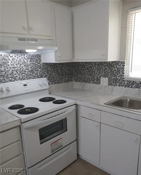 1909 Alwill Street, Unit C Las Vegas, NV 89106 - Photo 2 of 9 Kitchen with white electric range, white cabinets, light countertops, and under cabinet range hood