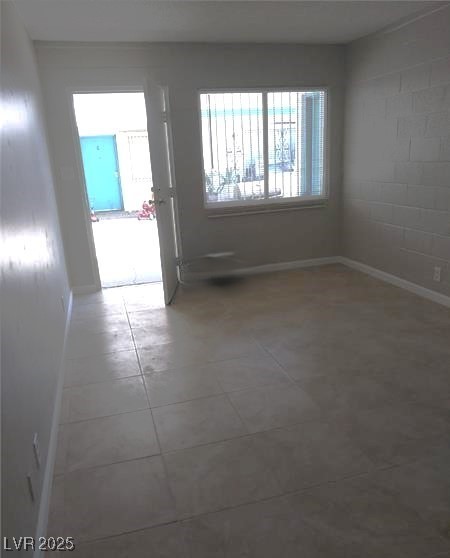 1909 Alwill Street, Unit C Las Vegas, NV 89106 - Photo 3 of 9 Unfurnished room featuring baseboards and concrete block wall