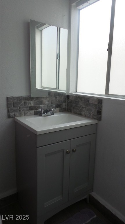 1909 Alwill Street, Unit C Las Vegas, NV 89106 - Photo 5 of 9 Bathroom featuring vanity and tasteful backsplash