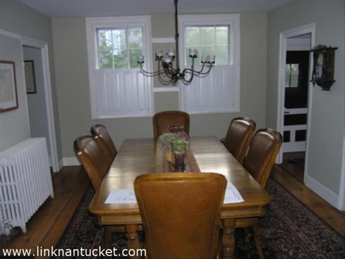 16 Vestal Street Nantucket, MA 02554 - Photo 7 of 10 a table chair sitting in a room and dining room with wooden floor