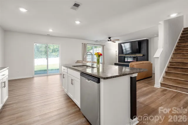a kitchen with granite countertop lots of counter top space and stainless steel appliances