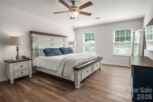 a bedroom with a large bed and a window