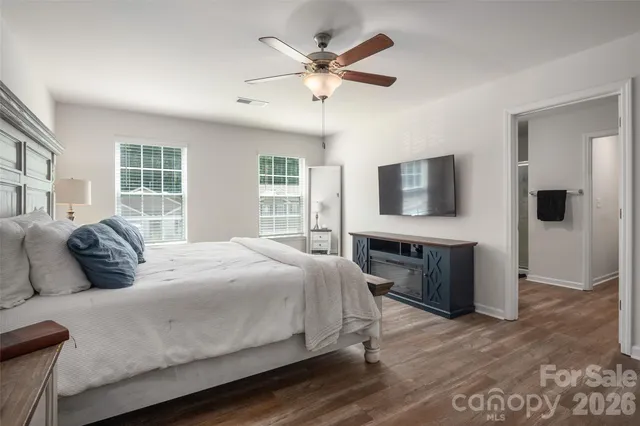 a bedroom with a balcony a bed and a flat screen tv