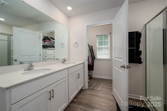 a bathroom with a double vanity sink and mirror
