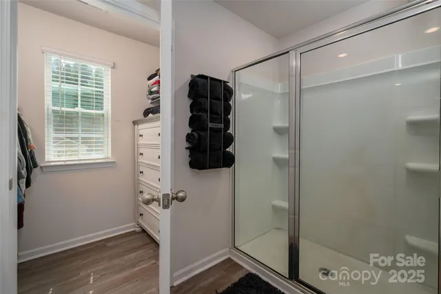a bathroom with a shower and a window