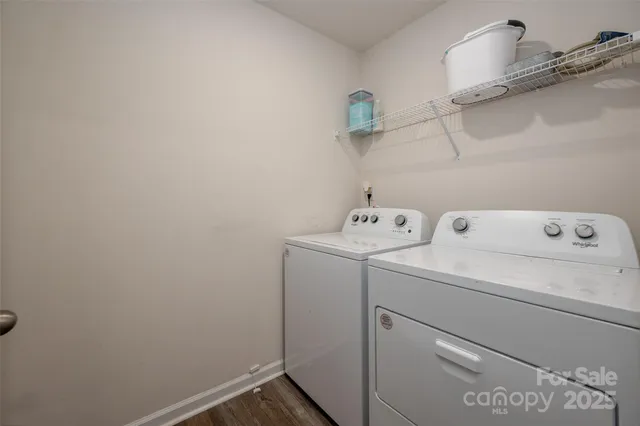 a view of a patio with table and chairs under an umbrella