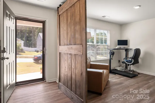a view of a livingroom with workspace and a window
