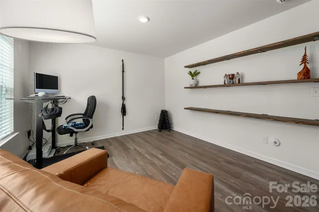 a bedroom with furniture and wooden floor
