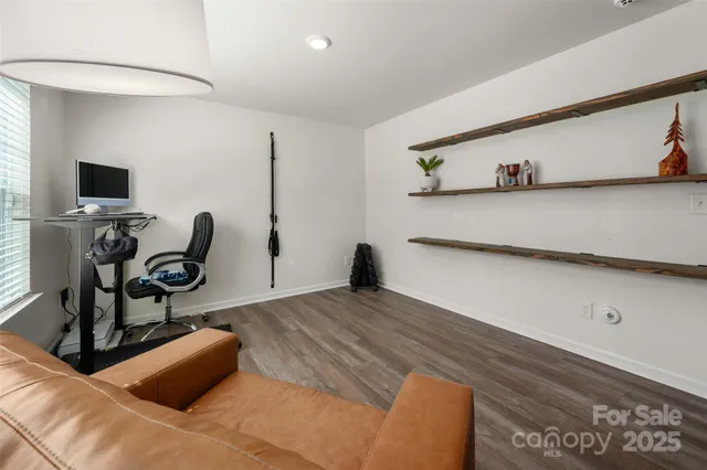 a bedroom with furniture and wooden floor