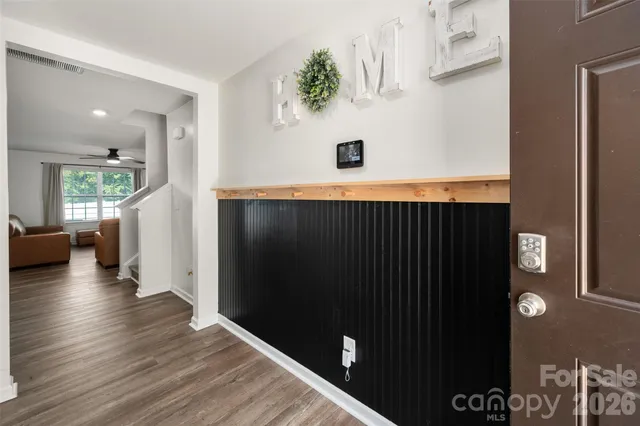 a view of a hallway with wooden floor and staircase