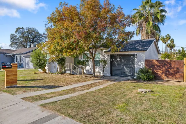 a front view of a house with a garden