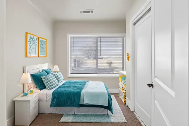 a bedroom with a bed and a window