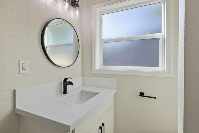 a bathroom with a sink and a mirror