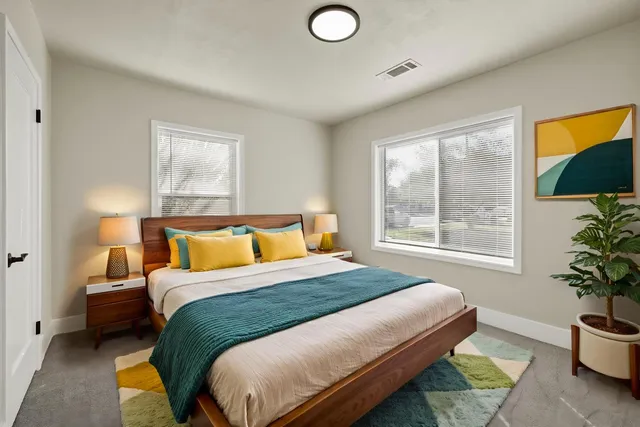 a bedroom with a bed and a potted plant