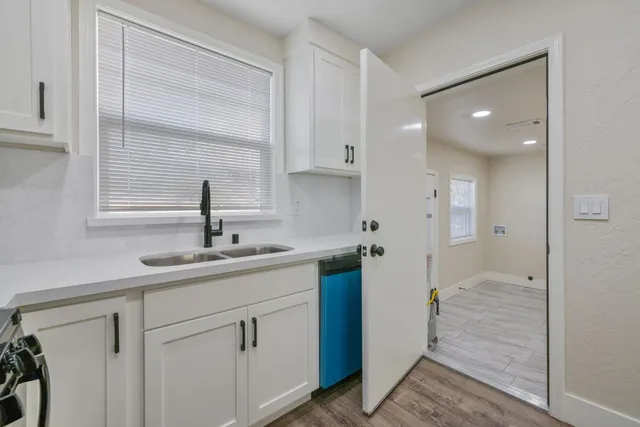 a kitchen with a sink cabinets and window