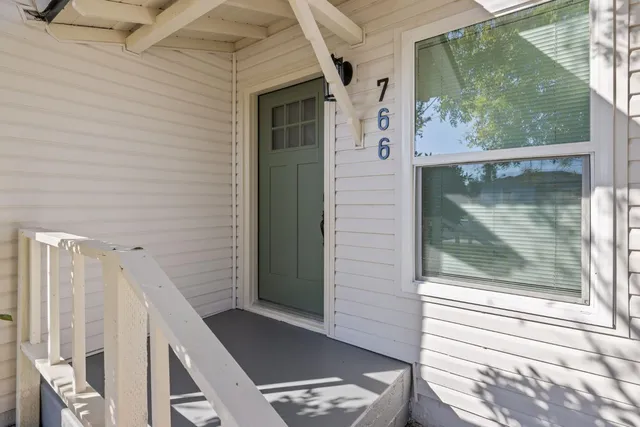 a view of a door and a window of the house