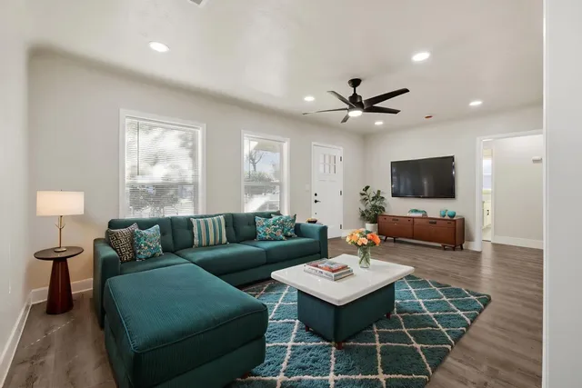 a living room with furniture and a flat screen tv