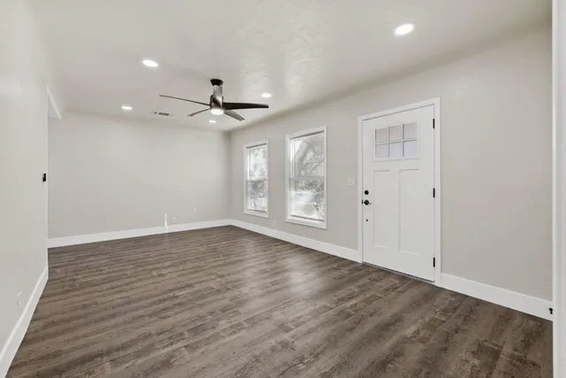 wooden floor in an empty room with a window
