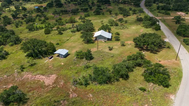 an aerial view of residential houses with outdoor space