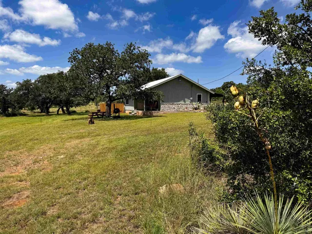 a view of a house with a yard and garage