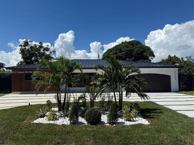 a view of a house with a yard and a garden