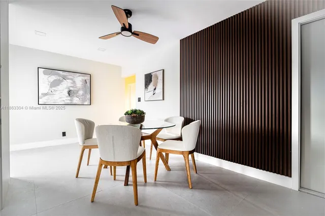 a view of a livingroom with a chair and potted plant