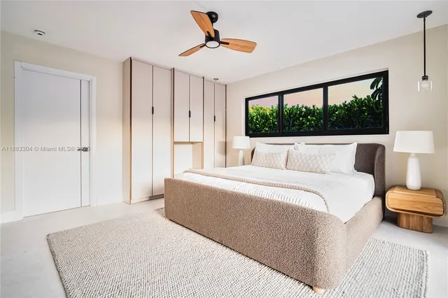 a bedroom with a large bed and a window