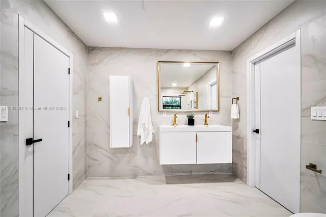 a bathroom with a glass door shower