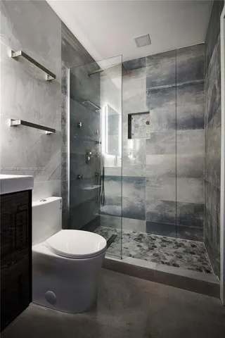 a bathroom with a sink mirror and a shower