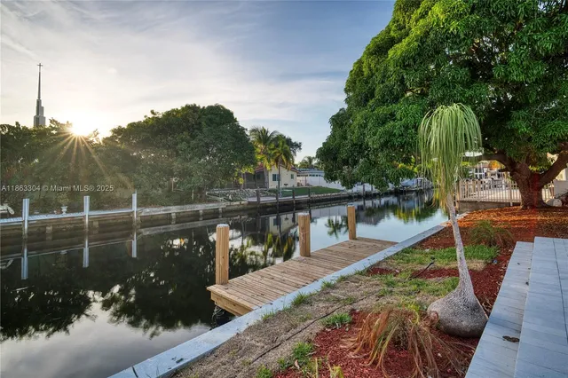 an aerial view of a house with swimming pool garden and patio