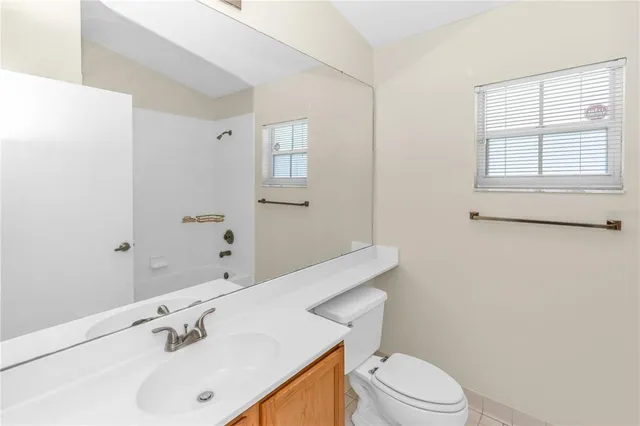 a bathroom with a sink a toilet and window