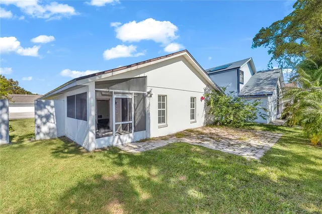 a view of a house with a yard and porch