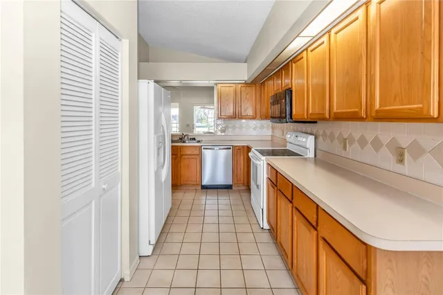 a kitchen with stainless steel appliances granite countertop sink stove and cabinets