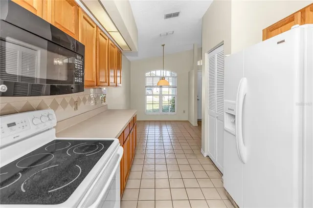 a kitchen with a sink a refrigerator and a stove